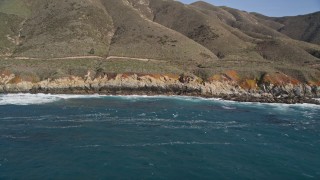 AXSF16_055 - 5K aerial stock footage of tilting up to reveal coastal cliffs and hills, Carmel, California