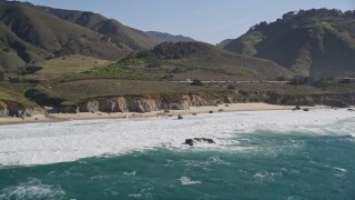 AXSF16_062 - 5K aerial stock footage of flying by waves crashing on small beach, Carmel, California