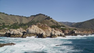 AXSF16_065 - 5K aerial stock footage flyby waves crashing into rocks below coastal homes, Carmel, California