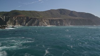 AXSF16_070 - 5K aerial stock footage of tilting from coastal rock formations, revealing cliffs and Bixby Creek Bridge, Big Sur, California