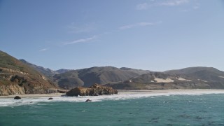 AXSF16_083 - 5K aerial stock footage of tilting from ocean kelp, reveal coastal rock formations and a beach, Big Sur, California