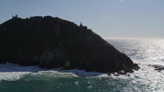 AXSF16_085 - 5K aerial stock footage tilt from ocean revealing Point Sur Light Station, Big Sur, California