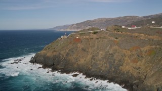 AXSF16_086 - 5K aerial stock footage of flying away from the Point Sur Light Station on coastal cliffs, Big Sur, California