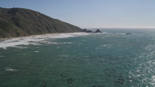 AXSF16_097 - 5K aerial stock footage tilt from ocean kelp to reveal steep cliffs, Big Sur, California