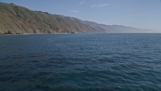 AXSF16_104 - 5K aerial stock footage of tilting up from the ocean to reveal coastal cliffs, Big Sur, California