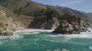 AXSF16_121 - 5K aerial stock footage of tilting from the ocean to reveal McWay Falls, Big Sur, California
