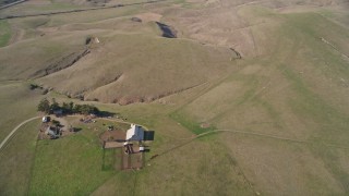 AXSF16_146 - 5K aerial stock footage reverse view of open lands, revealing a ranch house, Central California