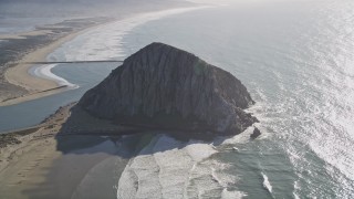 AXSF16_152 - 5K aerial stock footage flying by Morro Rock in Morro Bay, California