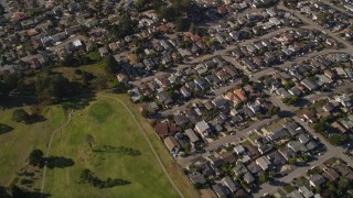 AXSF16_154 - 5K aerial stock footage of a reverse view of suburban homes, reveal Morro Bay Golf Course, California