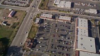 AXSF16_157 - 5K aerial stock footage of a reverse view of shopping centers and suburban homes in San Luis Obispo, California