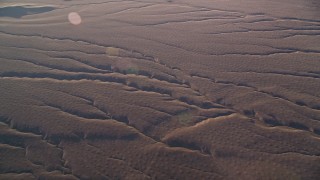 AXSF17_028 - 5K aerial stock footage of flying by deep cracks in the desert, Cuyama Valley, California