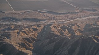 AXSF17_032 - 5K aerial stock footage of a reverse view of a dry riverbed and Caliente Range mountains, Cuyama Valley, California