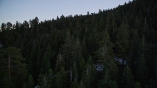 AXSF17_063 - 5K aerial stock footage of flying low over patches of snow and trees in Los Padres National Forest, California, twilight