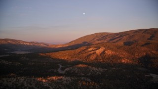 AXSF17_065 - 5K aerial stock footage of flying by mountains with moon above, Los Padres National Forest, California, sunset