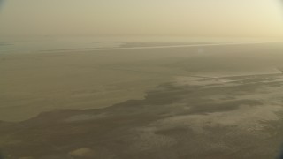 CAP_001_002 - HD stock footage aerial video of flying over a hazy desert at sunrise in Al Selmiyyah, Abu Dhabi, UAE