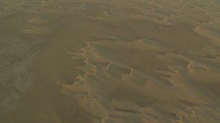 CAP_001_006 - HD stock footage aerial video of a reverse view of desert sand dunes at sunrise in Al Selmiyyah, Abu Dhabi, UAE