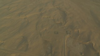 CAP_001_010 - HD stock footage aerial video of buildings and desert sand dunes at sunrise, Al Gharbia, Abu Dhabi, UAE