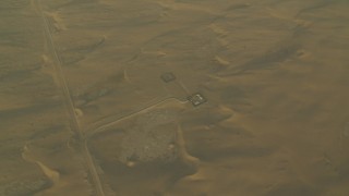CAP_001_011 - HD stock footage aerial video of orbiting buildings and sand dunes at sunrise, Al Gharbia, Abu Dhabi, UAE