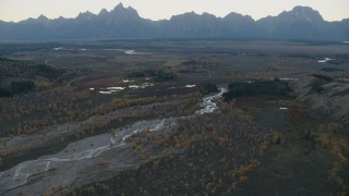 CAP_002_004 - HD stock footage aerial video of autumn trees around a river near mountains, Jackson Hole, Wyoming twilight