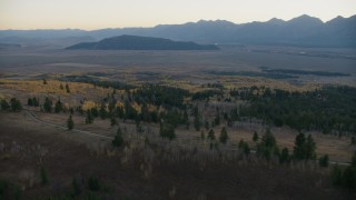 CAP_002_012 - HD stock footage aerial video fly over country road and autumn trees, Jackson Hole, Wyoming, twilight