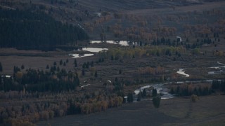 CAP_002_019 - HD stock footage aerial video of autumn trees around small lakes and a river, Jackson Hole, Wyoming, twilight