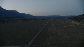 CAP_002_022 - HD stock footage aerial video of flying by Highway 26, Jackson Hole, Wyoming, twilight