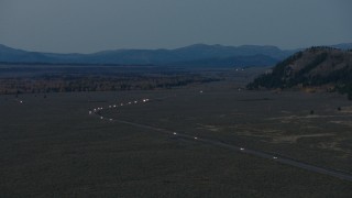CAP_002_023 - HD aerial stock footage video of light traffic on Highway 26, Jackson Hole, Wyoming, twilight