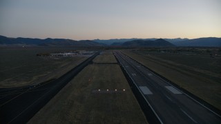 CAP_002_024 - HD stock footage aerial video pan to reveal and fly over Jackson Hole Airport, Wyoming, twilight
