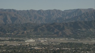 CAP_004_004 - HD stock footage aerial video of Bob Hope International Airport and mountain ridges in Burbank, California
