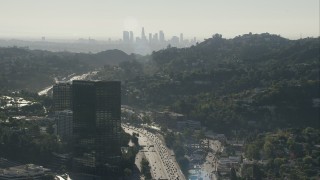 CAP_004_005 - HD stock footage aerial video fly over office building to approach the skyline of Downtown Los Angeles, California