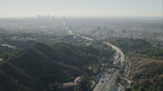 CAP_004_009 - HD stock footage aerial video approach the skyline of Downtown Los Angeles, California from freeway pass