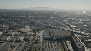 CAP_004_019 - HD stock footage aerial video approach office building beside freeway in Boyle Heights, Los Angeles, California