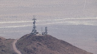 CAP_006_014 - HD stock footage aerial video of mountaintop radio towers in the Mojave Desert, San Bernardino County, California