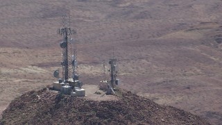 CAP_006_015 - HD stock footage aerial video of radio towers on a Mojave Desert mountain summit in San Bernardino County, California
