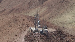 CAP_006_017 - HD stock footage aerial video of a group of radio towers on a Mojave Desert mountain in San Bernardino County, California