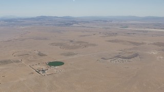 CAP_006_021 - HD stock footage aerial video of a crop field and a Mojave Desert monastery in Newberry Springs, California