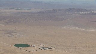 CAP_006_027 - HD stock footage aerial video zoom to a wiper view of a lonely Mojave Desert monastery and crop circle in Newberry Springs, California