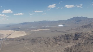 CAP_006_047 - HD stock footage aerial video of a view of the three solar arrays at Ivanpah Solar Electric Generating System in California next to a highway