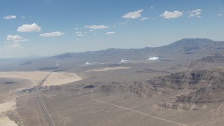 CAP_006_048 - HD stock footage aerial video of a view of the three solar arrays at Ivanpah Solar Electric Generating System in California next to I-15