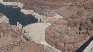 CAP_008_005 - HD stock footage aerial video orbit Hoover Dam as cars cross the top of the structure, Nevada