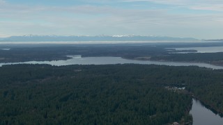 CAP_009_003 - HD stock footage aerial video of a view of the Olympic Mountain range, seen from Anderson Island in Puget Sound, Washington