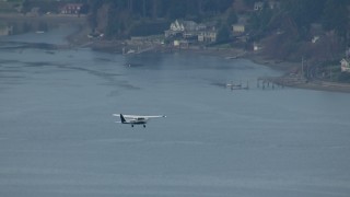CAP_009_011 - HD stock footage aerial video track an airplane flying over Puget Sound, and reveal waterfront homes, Washington