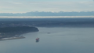 CAP_009_019 - HD stock footage aerial video of a cargo ship sailing Puget Sound and the Olympic Mountains, Washington