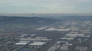 CAP_009_032 - HD stock footage aerial video of the Downtown Seattle skyline seen from warehouse buildings in Kent, Washington