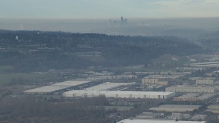 CAP_009_033 - HD stock footage aerial video of the Downtown Seattle city skyline seen from warehouse buildings in Kent, Washington