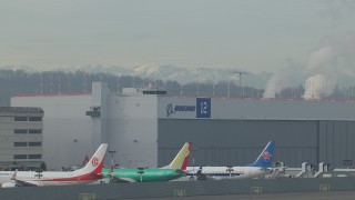 CAP_009_043 - HD stock footage aerial video flyby commercial jet and zoom in on a hangar at Boeing Field, Washington