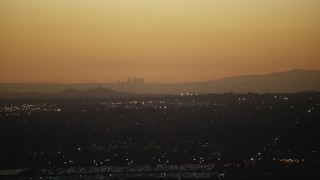 CAP_010_002 - HD stock footage aerial video of the Downtown Los Angeles skyline at twilight seen from homes in the San Gabriel Valley, California