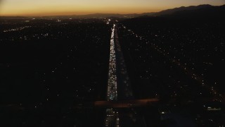 CAP_010_003 - HD stock footage aerial video tilt from heavy traffic on the I-10 freeway at twilight through the in the San Gabriel Valley, California