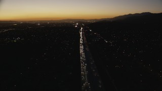 CAP_010_004 - HD stock footage aerial video tilt down to heavy traffic on the I-10 freeway at sunset through the in the San Gabriel Valley, California