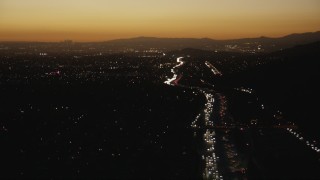 CAP_010_005 - HD stock footage aerial video follow heavy traffic on the I-10 freeway at sunset through the in the San Gabriel Valley, California